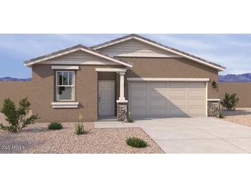 New construction home featuring a two-car garage and covered front entry with stone accents at 18232 W La Senda Dr, Surprise, AZ 85387