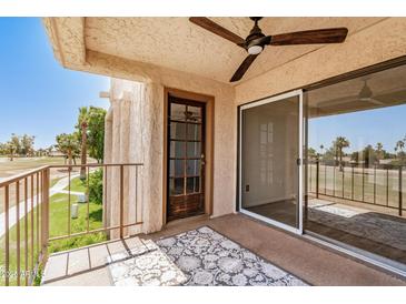 Charming patio features a ceiling fan and views of lush greenery at 7061 E Broadway Rd # 48, Mesa, AZ 85208