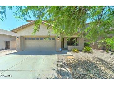 Charming single-story home featuring a two-car garage and well-maintained gravel landscaping at 11633 W Jefferson St, Avondale, AZ 85323