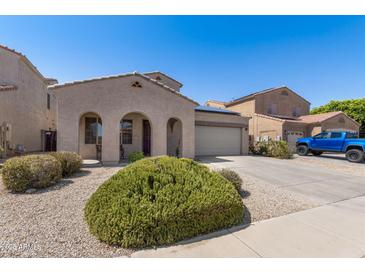 View of a single Gathering house with an arched porch, two car garage, desert landscaping and a blue truck at 16118 W Port Au Prince Ln, Surprise, AZ 85379