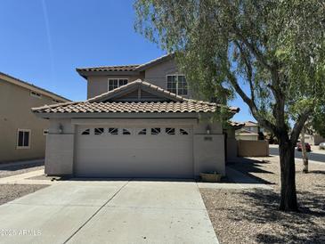 Charming two-story home featuring a tile roof and a spacious two car garage at 22632 W Solano Dr, Buckeye, AZ 85326