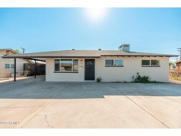 Front exterior showcasing a well-maintained yard, covered parking and freshly painted façade of this lovely Phoenix home at 2342 N 40Th Ave, Phoenix, AZ 85009