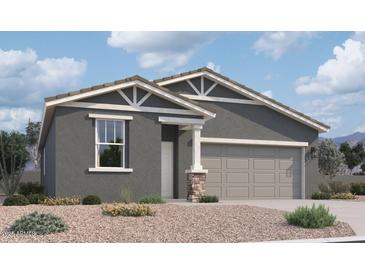 Charming single-story home with a two-car garage, desert landscaping and stone column at 47705 W Kenner Dr, Maricopa, AZ 85139