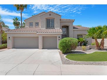 Stunning home featuring desert landscaping, a tile roof, and a spacious three-car garage at 641 W Oriole Way, Chandler, AZ 85286
