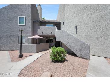 Charming condo exterior with a private patio, walkway, and desert landscaping at , Mesa, AZ 85201
