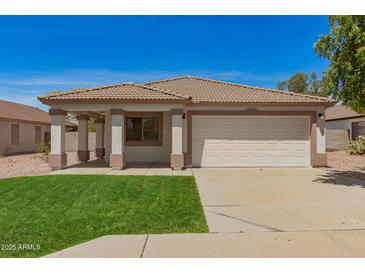 Charming single-story home featuring a desert landscape, a two-car garage, and a cozy front porch at 10212 E Caballero St, Mesa, AZ 85207