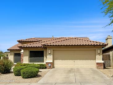 Charming single-story home featuring a tile roof, desert landscaping, and an attached two-car garage at 4208 E Hamblin Dr, Phoenix, AZ 85050
