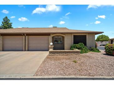 Charming single-story home featuring a two-car garage and a well-maintained, xeriscaped front yard at 520 S Greenfield Rd # 7, Mesa, AZ 85206
