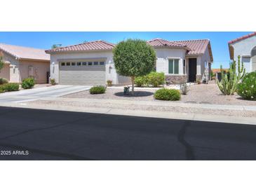 Charming single-story home with tile roof, desert landscaping, and a two-car garage at 60 S Agua Fria Ln, Casa Grande, AZ 85194