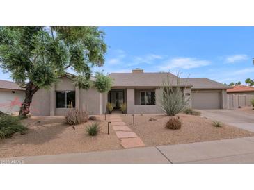 Charming home featuring desert landscaping, a stone walkway and a neutral color palette at 7806 E Via De La Entrada --, Scottsdale, AZ 85258