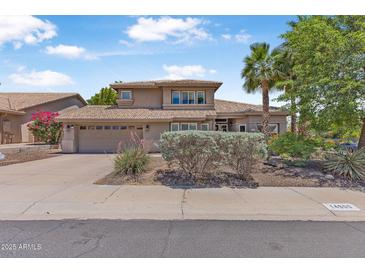 Charming two-story home with a well-manicured lawn, desert landscaping and attached garage at 14609 S 24Th Way, Phoenix, AZ 85048