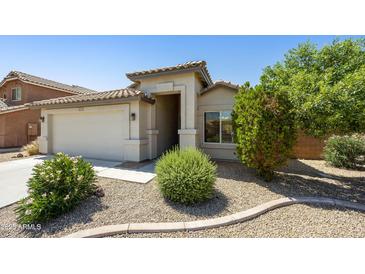 Charming single-story home showcasing desert landscaping and a two-car garage at 2011 W Burgess Ln, Phoenix, AZ 85041