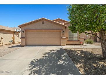 Charming single-story home featuring a spacious two-car garage and a well-maintained front yard at 43938 W Colby Dr, Maricopa, AZ 85138