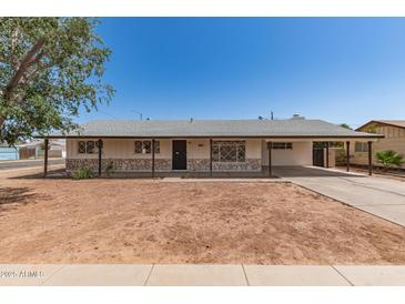 Charming single-story home featuring a covered carport, stone accents and low maintenance front yard at 501 W Dublin St, Chandler, AZ 85225
