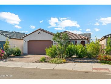 Charming single-story home featuring desert landscaping, a brick-paved driveway, and a two-car garage at 12672 W Marguerite Ave, Avondale, AZ 85323