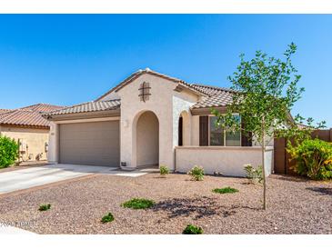 Charming single-story home with a desert landscaped front yard and neutral paint at 19595 W San Miguel Ave, Litchfield Park, AZ 85340