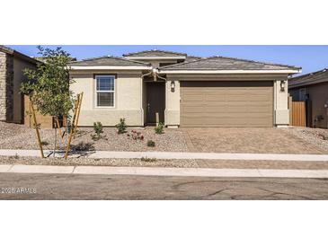 Charming single-story home featuring a two-car garage, desert landscaping, and a welcoming front entrance at 3129 S 155Th Ln, Goodyear, AZ 85338