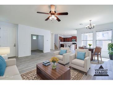 Bright living room features neutral tones, open floor plan, and stylish furnishings at 3514 S Posse Trl, Gilbert, AZ 85297