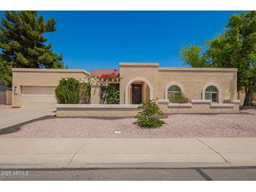 Charming single-story home with a well-maintained stucco exterior and inviting curb appeal at 400 W Crofton St, Chandler, AZ 85225