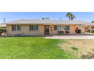 Charming single-story home features a well-maintained front yard with mature landscaping at 6255 E Rose Circle Dr, Scottsdale, AZ 85251