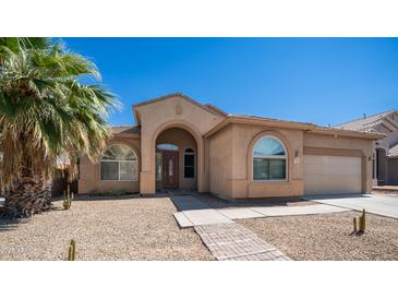 Inviting home exterior featuring desert landscaping, stucco finish, and arched entrance at 757 W Carob Way, Chandler, AZ 85248
