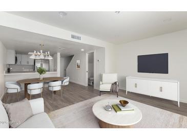 Bright living room featuring an open floor plan with a modern kitchen and stylish furniture at 122 S Hardy Dr # 62, Tempe, AZ 85281
