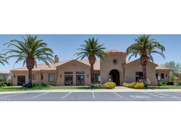 Community clubhouse with desert landscaping, palm trees, and ample parking at 1367 S Country Club S Dr # 1125, Mesa, AZ 85210