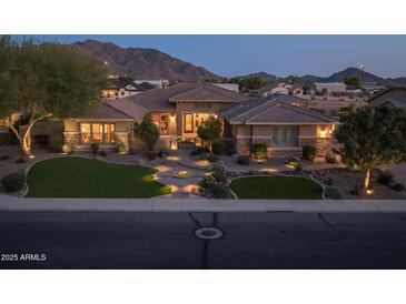 Stunning single-story home with meticulously landscaped front yard and mountain views at 3119 E Bellflower Dr, Gilbert, AZ 85298