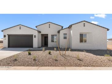 Charming single-story home with a gravel front yard, desert landscaping, and a two-car garage at 37695 W Santa Maria St, Maricopa, AZ 85138