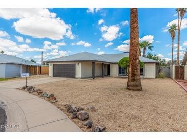 A lovely single-story home, featuring a wide driveway, with a two-car garage and xeriscaped front yard at 4226 W Evans Dr, Phoenix, AZ 85053