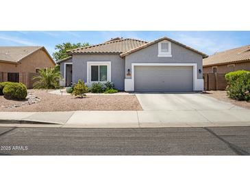 Charming single-story home with a well-manicured yard and a two-car garage at 4231 E Augusta Ave, Chandler, AZ 85249