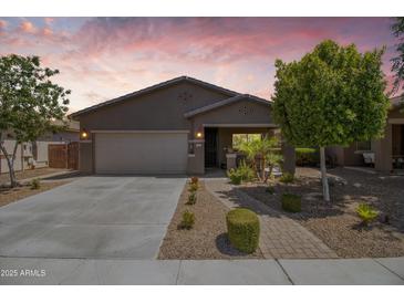 Charming single-story home with a well-manicured front yard and two car garage at 838 W Basswood Ave, Queen Creek, AZ 85140