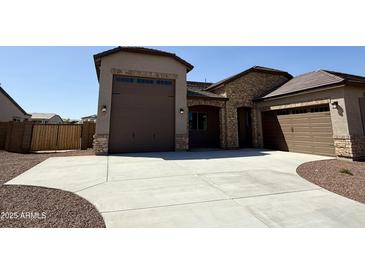 Beautiful, single-Gathering home with a three car garage and stone facade accents at 17308 W Royal Palm Rd, Waddell, AZ 85355