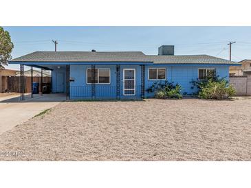 Charming single-story home featuring a covered porch, metalwork details, and low-maintenance landscaping at 2117 W 2Nd St, Mesa, AZ 85201