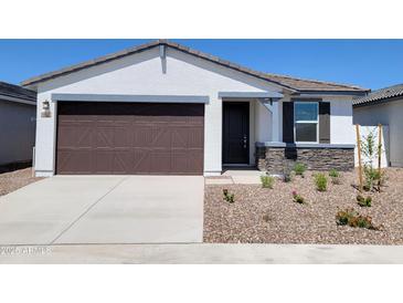 Charming single-story home featuring a two-car garage, stone accents, and a well-maintained gravel front yard at 3510 N Camden Dr, Florence, AZ 85132