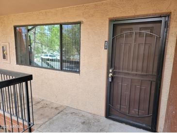 Exterior shot of unit entry featuring a steel security door and window at 3810 N Maryvale Pkwy # 2077, Phoenix, AZ 85031