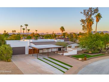 Stunning desert home with a long driveway, carport, and gorgeous mountain views at 4040 E Becker Ln, Phoenix, AZ 85028
