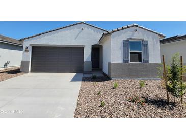 Charming single-story home featuring a two-car garage and a low-maintenance front yard at 8576 W Yorktown Ct, Florence, AZ 85132