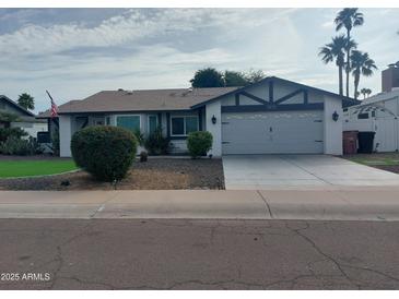 Charming single-story home featuring a well-maintained front yard, attached garage, and inviting curb appeal at 8879 E Friess Dr, Scottsdale, AZ 85260