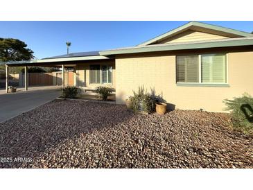 Charming home with a cozy front porch and well-maintained landscaping with brick exterior at 9615 N 34Th Ave, Phoenix, AZ 85051
