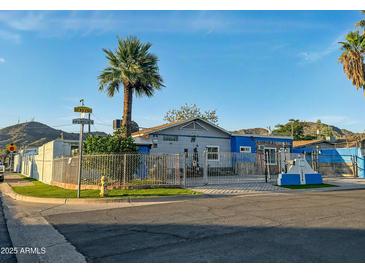 Charming fenced single-story home with mature landscaping, mountain views, and a unique desert charm at 1226 W Purdue Ave, Phoenix, AZ 85021