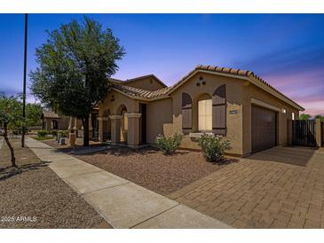 Beautiful single-story home boasts a well-manicured lawn, brick driveway, and attached two-car garage at 1960 S Falcon Dr, Gilbert, AZ 85295