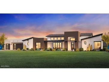 Stunning modern home with a manicured lawn and a dramatic sunset backdrop at 21963 E Sunset Dr, Queen Creek, AZ 85142