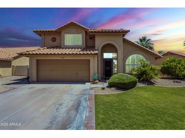 Charming two-story home featuring a well-manicured lawn, a two car garage and a terra cotta roof at 2340 W Myrtle Dr, Chandler, AZ 85248