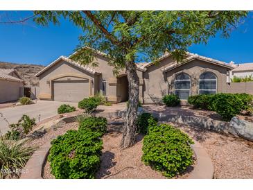 Charming single-story home featuring a well-manicured front yard and a two-car garage at 2422 E Rockledge Rd, Phoenix, AZ 85048