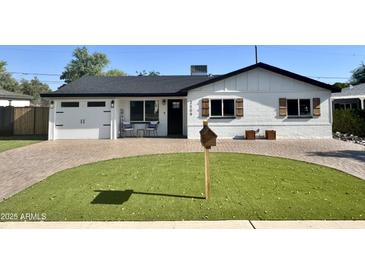 Charming single-Gathering home featuring a well-manicured lawn, brick driveway and shutters at 2509 E Meadowbrook Ave, Phoenix, AZ 85016