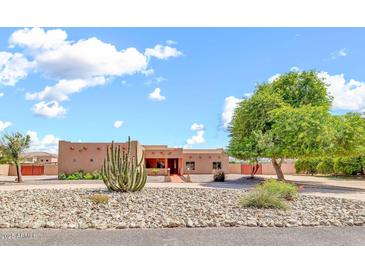 Single story home with desert landscaping, a large cactus and a circular driveway at 2699 E Claxton Rd, Gilbert, AZ 85297