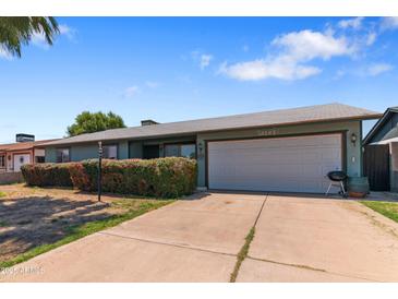 Charming single-story home with an attached two-car garage and beautiful desert landscaping at 3207 W Michigan Ave, Phoenix, AZ 85053