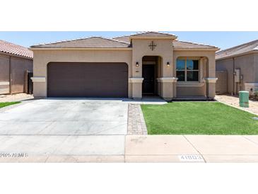 Charming single-story home featuring a desert landscape, brown garage door, and tiled roof at 41903 W Rojo St, Maricopa, AZ 85138