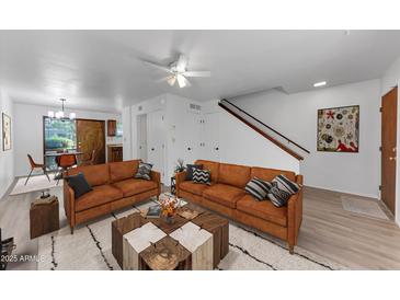 Inviting living room featuring a cozy seating area and stylish decor with hardwood floors and natural light at 4630 N 68Th St # 280, Scottsdale, AZ 85251